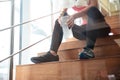 Attractive sportswoman sitting and drinking water