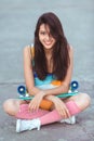 Sporty asian woman with skateboard Royalty Free Stock Photo