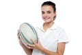 Attractive sporty girl posing with rugby ball