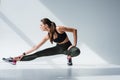 attractive sporty girl stretching legs before workout