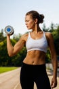 Attractive sporty girl with dumbbell