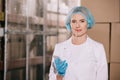 Attractive storekeeper in hairnet smiling at Royalty Free Stock Photo