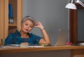 Attractive stressed and overworked Asian woman working at office laptop computer desk in stress feeling frustrated and upset in Royalty Free Stock Photo