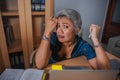 Attractive stressed and overworked Asian woman working at office laptop computer desk in stress feeling frustrated and upset in Royalty Free Stock Photo