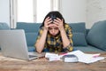 Attractive stressed woman managing finances, reviewing bank accounts, paying bills using laptop Royalty Free Stock Photo