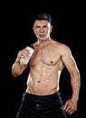 Attractive strong sport man drinking water holding bottle sweating tired after training gym