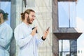 Attractive strong young man in office clothes speaks facetime Royalty Free Stock Photo