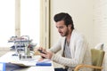 Attractive student or hipster style freelancer businessman working with laptop computer and mobile phone Royalty Free Stock Photo