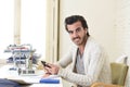 Attractive student or hipster style freelancer businessman working with laptop computer and mobile phone Royalty Free Stock Photo