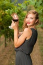 Attractive stylish woman drinking glass of red wine in vineyard Royalty Free Stock Photo