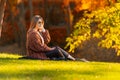 Attractive stylish young woman relaxing in a park. Royalty Free Stock Photo