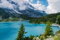 Attractive summer morning on the unique Oeschinensee Lake. Wonderful outdoor scene in the Swiss Alps with Bluemlisalp Royalty Free Stock Photo