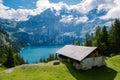 Attractive summer morning on the unique Oeschinensee Lake. Wonderful outdoor scene in the Swiss Alps with Bluemlisalp Royalty Free Stock Photo