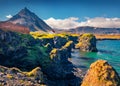 Attractive summer view of small fishing village at the foot of Mt. Stapafell - Arnarstapi or Stapi.