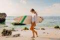 Attractive surfer girl with surfboard at beach