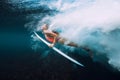 Attractive surfer woman dive underwater with under barrel wave and bubbles