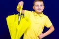 Attractive surprised caucasian blond schoolboy Shows unexpanded umbrella Royalty Free Stock Photo