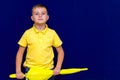 Attractive surprised caucasian blond schoolboy Shows unexpanded umbrella Royalty Free Stock Photo