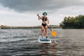 attractive tattooed girl with blue hair paddle boarding Royalty Free Stock Photo