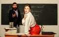 Attractive teacher in leather skirt. Cheeky teacher. Impudent student. Flirting with colleague. Science is sexy. Sexy