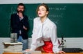 Attractive teacher in leather skirt. Cheeky teacher. Impudent student. Science is sexy. Sexy girl sit table while man