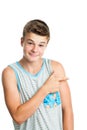 Attractive teen boy pointing aside with finger. Royalty Free Stock Photo