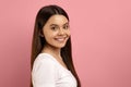 Attractive teen girl with beautiful smile looking over her shoulder at camera Royalty Free Stock Photo