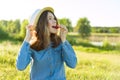 Attractive teen girl eating strawberry. Nature background, rural landscape, green meadow, country style Royalty Free Stock Photo