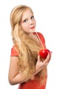 Attractive teen girl in the orange t-shirt holding an red apple Royalty Free Stock Photo
