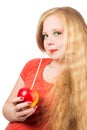 Attractive teen girl in the orange t-shirt holding an red apple Royalty Free Stock Photo