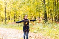 Attractive teen girl throwing leaves in the air