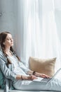 attractive teen girl using laptop and listening music with earphones Royalty Free Stock Photo