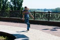 teenage girl quickly rides around the city on roller skates on a sunny summer day Royalty Free Stock Photo