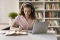Attractive teenage student girl listening audio course, studying in classroom Royalty Free Stock Photo