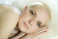 Attractive thoughtful blond bald woman lying