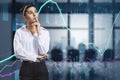Attractive thoughtful caucasian businesswoman with abstract glowing forex graph standing on blurry office interior background with Royalty Free Stock Photo