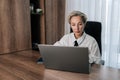 Attractive thoughtful concerned middle-aged adult 50s woman working on laptop computer in office looking to screen Royalty Free Stock Photo