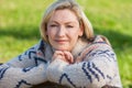 Attractive Thoughtful Middle Aged Woman Resting on Fence