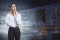 Attractive thoughtful young european businesswoman with abstract polygonal lines hologram standing on blurry office interior