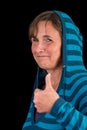 Attractive thumbs up lady in blue striped sweater