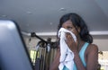 Attractive tired black afro American woman training at fitness club holding towel drying sweat exhausted and sweaty in treadmill Royalty Free Stock Photo