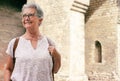 Attractive traveler senior woman visiting the Cathedral in Barcelona. Happy retired enjoying vacations and history
