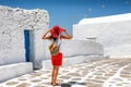 Traveler woman enjoys the classic Greek Cycladic architecture on Mykonos, island Greece Royalty Free Stock Photo