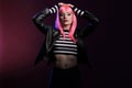 Attractive trendy girl with pink hair wearing leather jacket Royalty Free Stock Photo