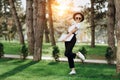 Attractive trendy happy hipster young woman with notebook in one hand in hat and sunglasses have fun in the park at the Royalty Free Stock Photo