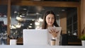 Businesswoman sitting in modern workplace and looking business data on digital tablet.