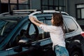 Wet girl washing black luxury car with blue cloth Royalty Free Stock Photo