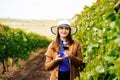 Attractive winemaker woman holding a glass of red wine in her hand and looking at the camera Royalty Free Stock Photo