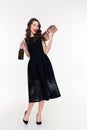 Attractive winking woman holding bottle of champagne and gift