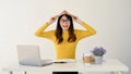 A wise Asian female college student in glasses is putting a book on her head Royalty Free Stock Photo